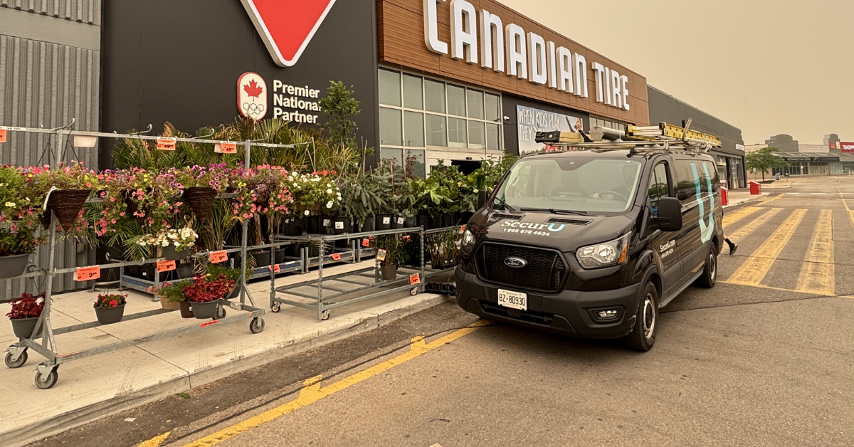 commercial security maintenance appointment with a SecurU service van outside of a retail job site